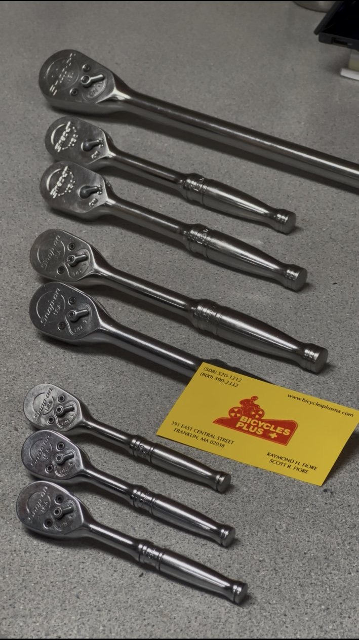 Snap-on ratchets beside a Bicycles Plus business card